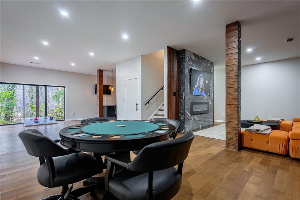 Playroom featuring a fireplace and light hardwood / wood-style floors