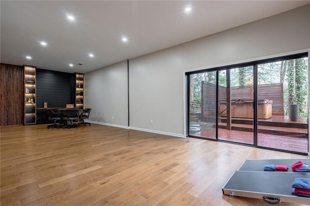 Workout area featuring light wood-type flooring