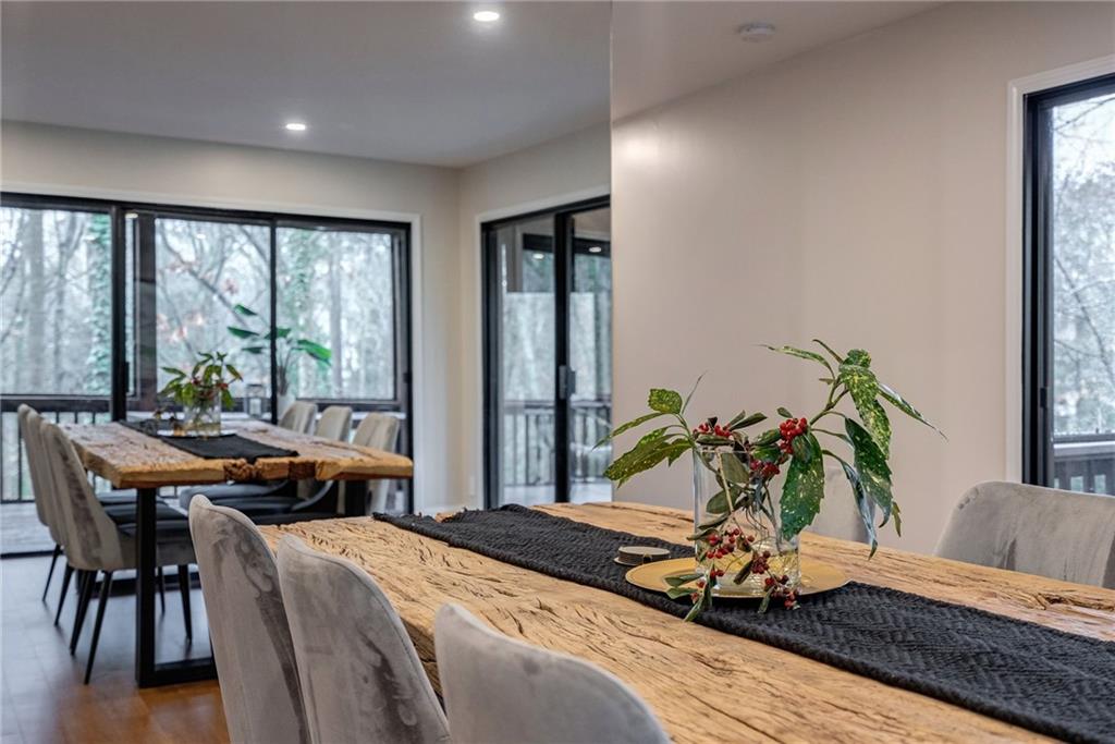 Dining space featuring a wealth of natural light and dark wood-type flooring