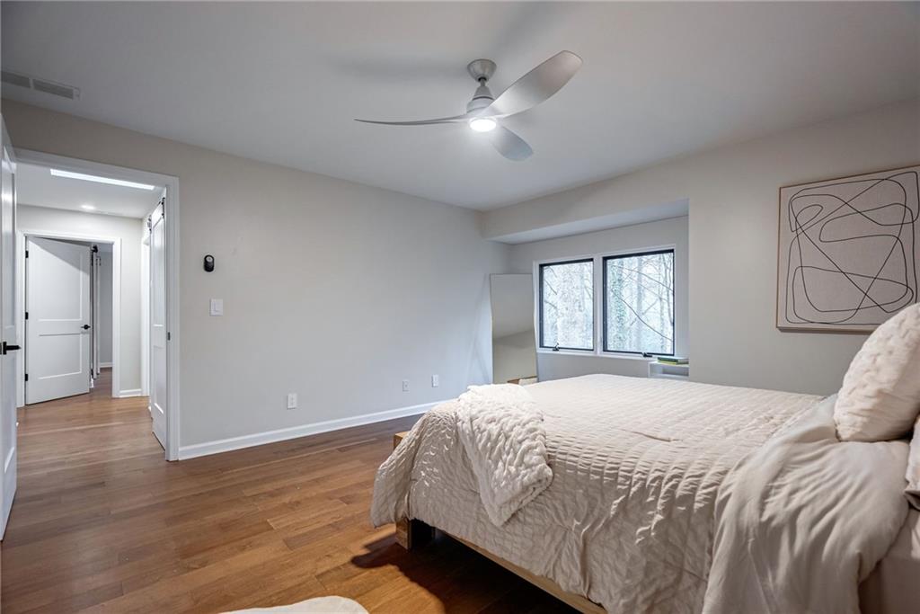 Bedroom featuring hardwood / wood-style flooring and ceiling fan