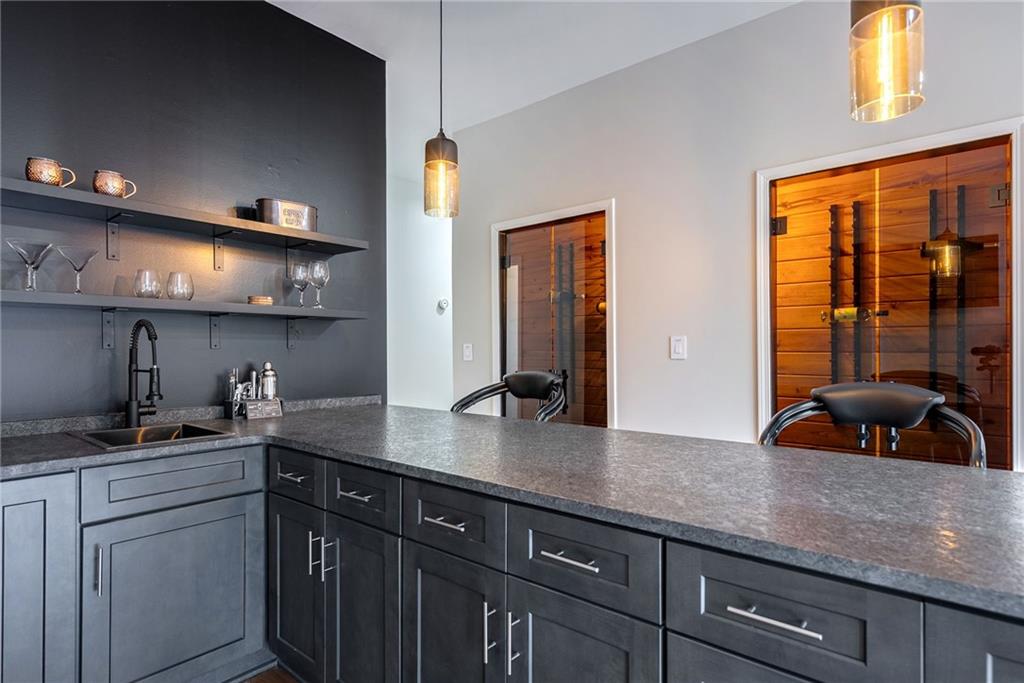 Kitchen with pendant lighting, kitchen peninsula, and sink