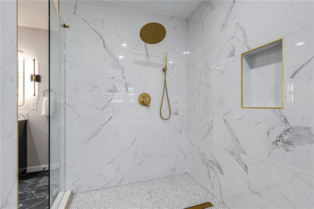 Bathroom with vanity and a tile shower