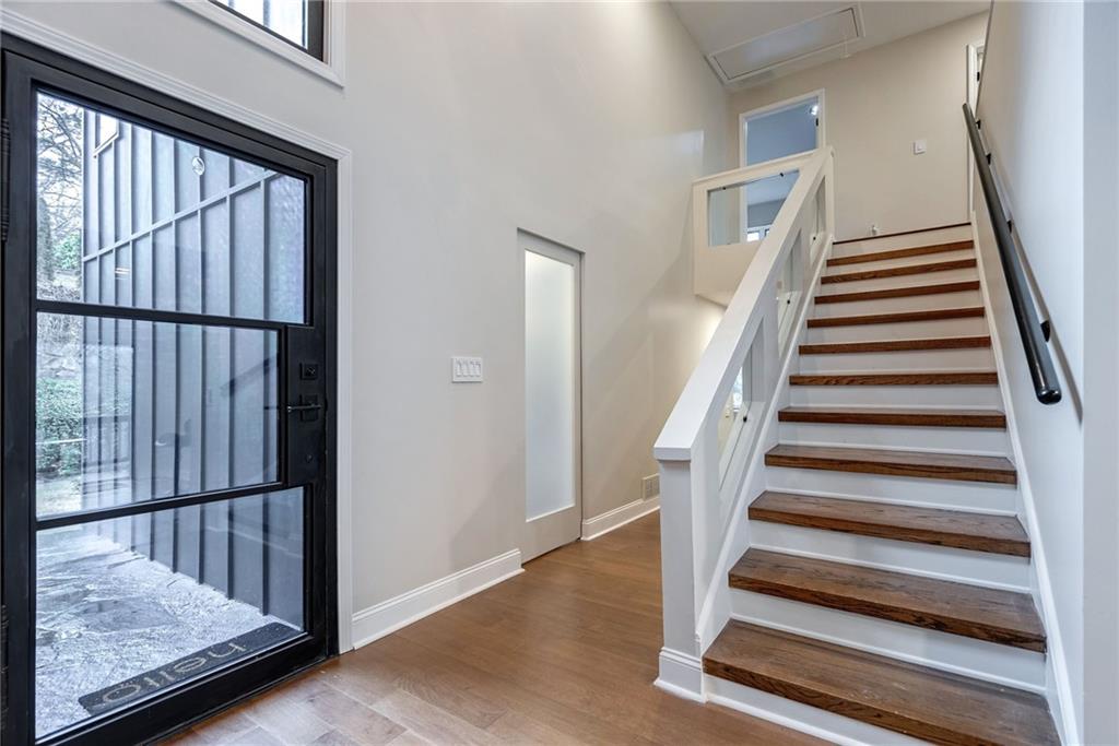Stairway featuring light wood-type flooring