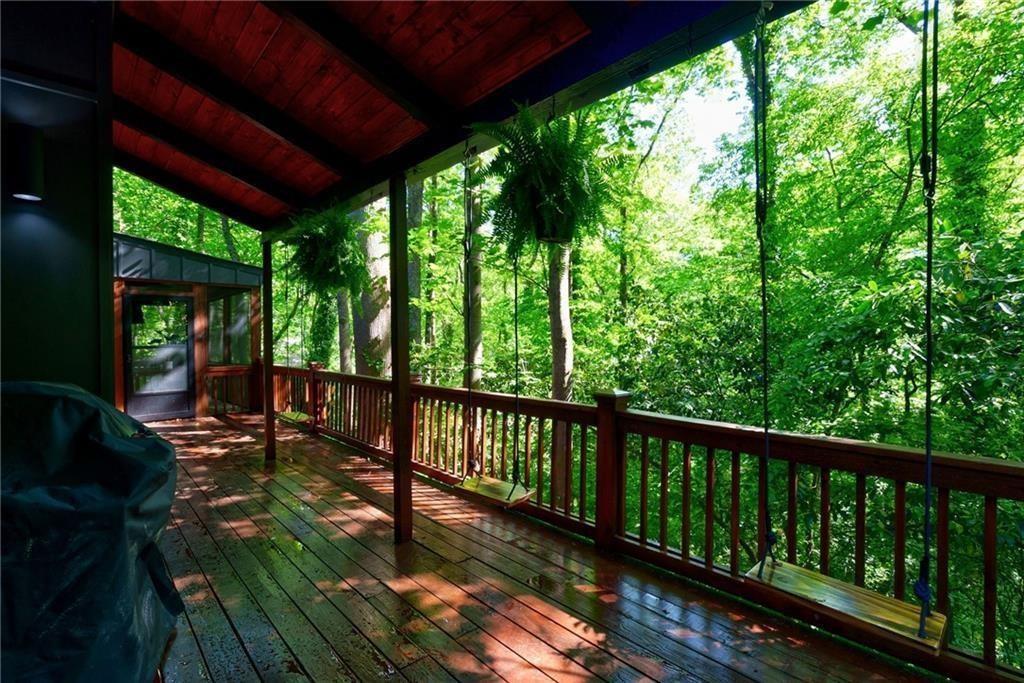 Wooden terrace featuring a grill