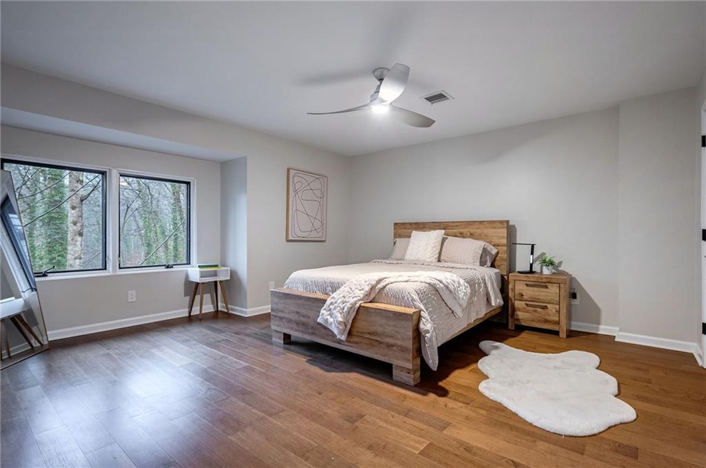 Bedroom featuring dark hardwood / wood-style floors and ceiling fan