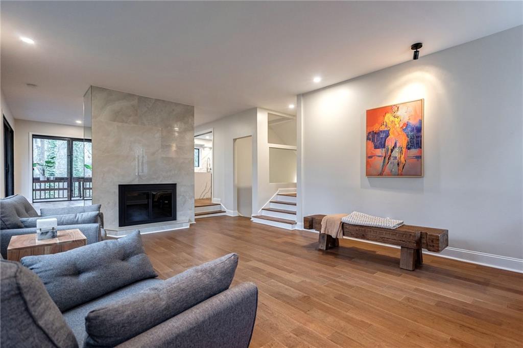 Living room featuring a premium fireplace and light hardwood / wood-style floors
