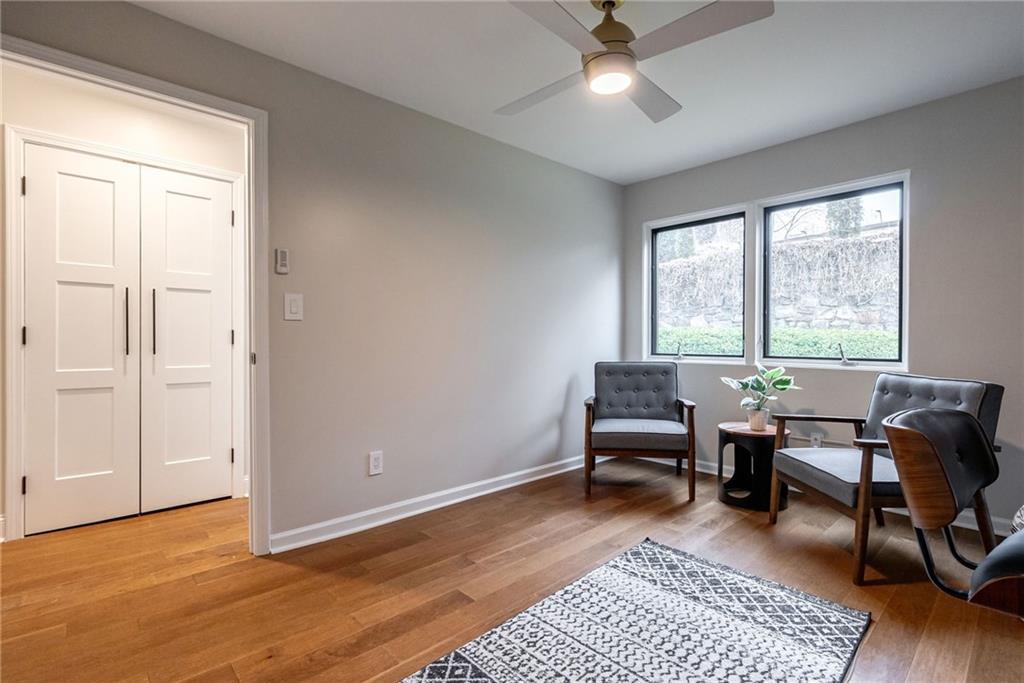 Sitting room featuring light hardwood / wood-style flooring and ceiling fan
