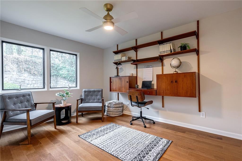 Home office featuring ceiling fan and light wood-type flooring