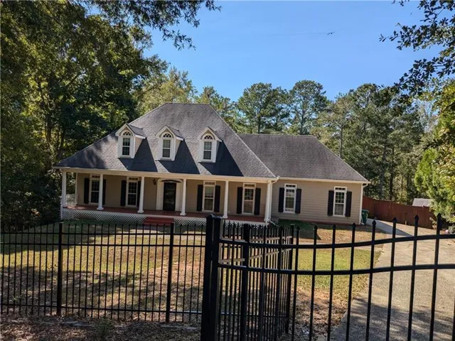 View of front of house with a porch and a front lawn