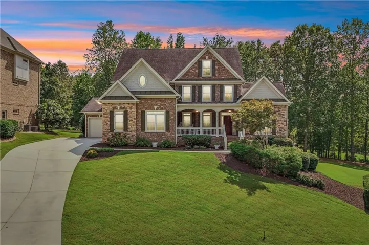 Brick and siding exterior featuring gabled rooflines, a covered front porch, and a 3 Car Garage