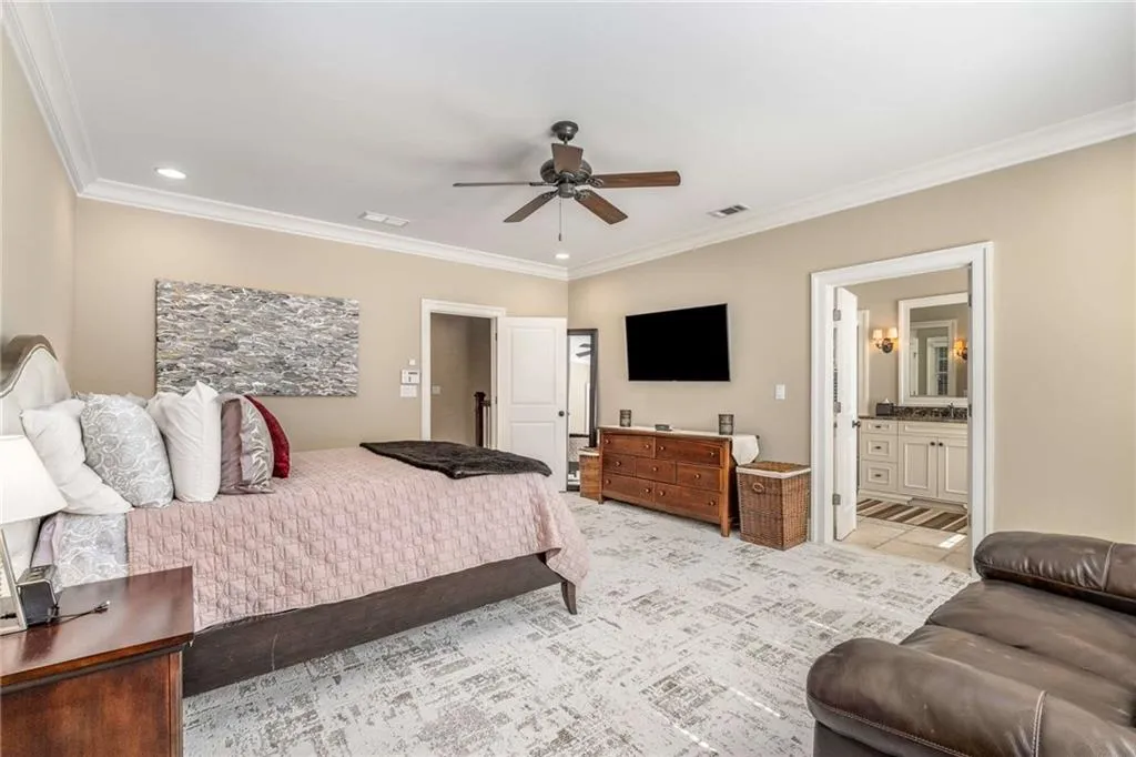 Bedroom featuring recessed lighting, visible vents, ensuite bathroom, ornamental molding, and ceiling fan