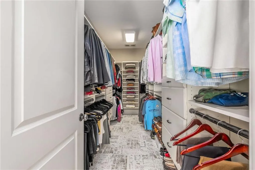 Spacious closet featuring visible vents