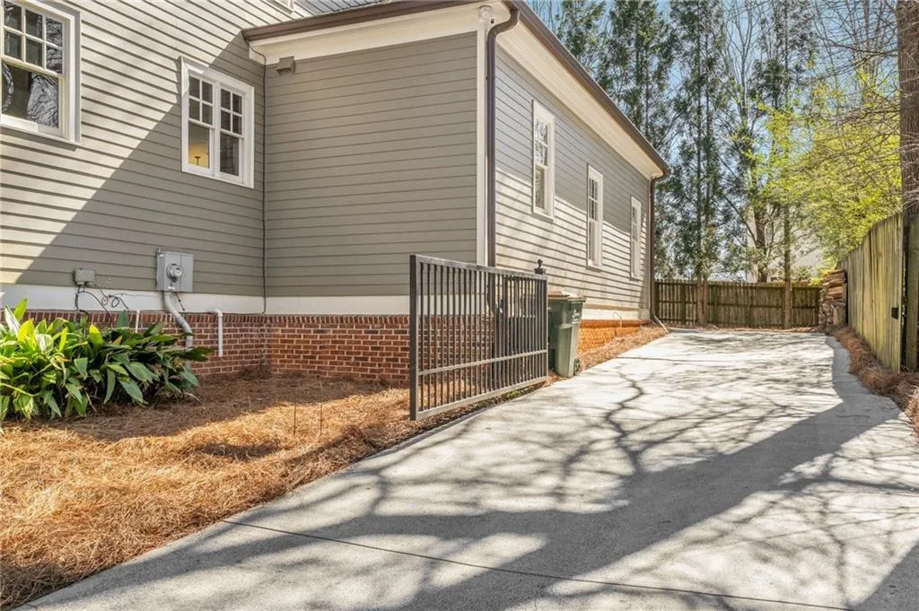 View of side of property featuring fence