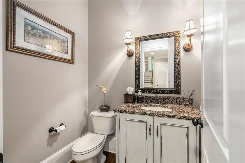 Bathroom with baseboards, vanity, and toilet