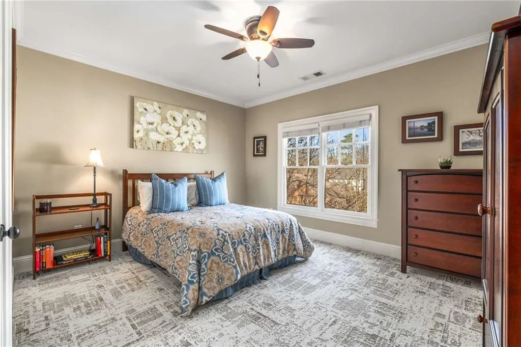 Bedroom featuring crown molding, visible vents, carpet flooring, ceiling fan, and baseboards