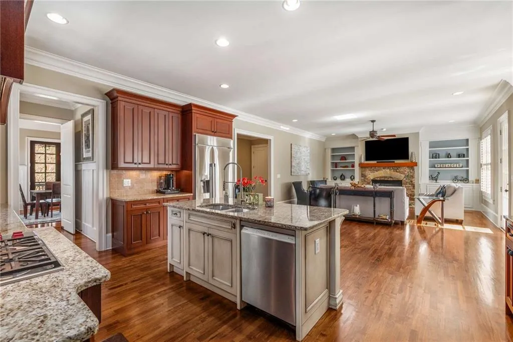 Kitchen featuring dark wood-style floors, appliances with stainless steel finishes, plenty of natural light, and a sink