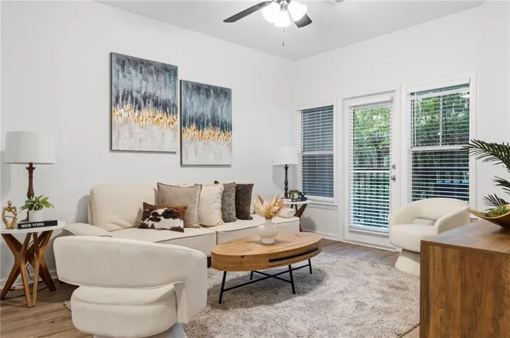 Recessed lighting, ceiling fan, wood-finish flooring, white walls, and large windows with blinds