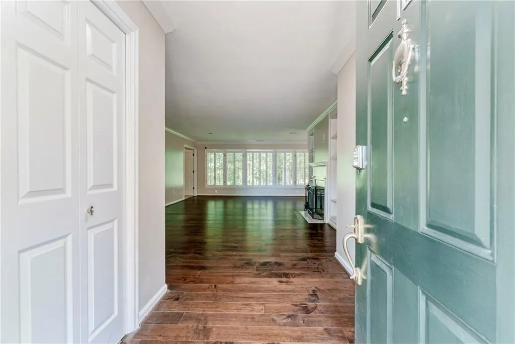Entryway featuring dark wood-type flooring and ornamental molding