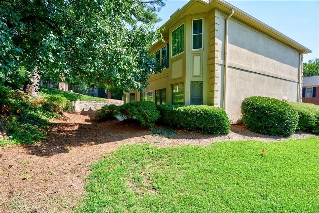 View of side of property featuring a lawn
