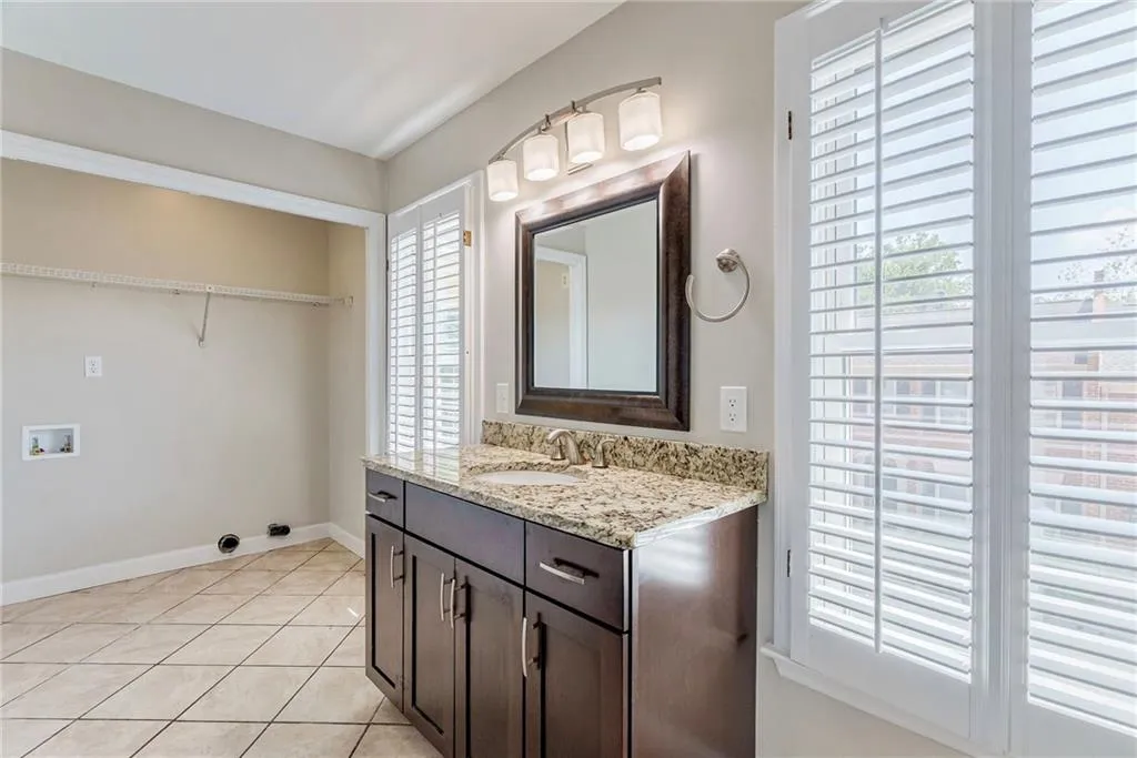 Bathroom with vanity and light tile patterned floors