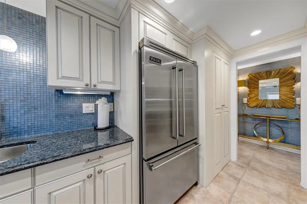 Sophisticated custom cabinets with fine trim, blue eyes granite and sapphire blue back splash