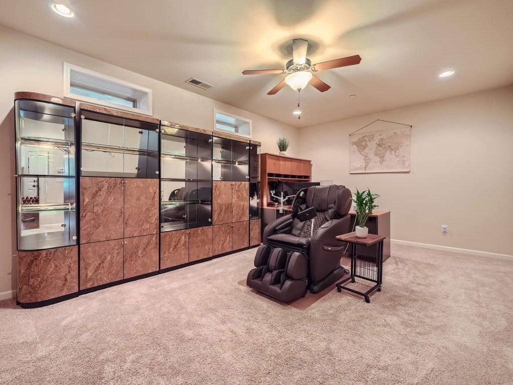 Office space featuring light carpet and ceiling fan
