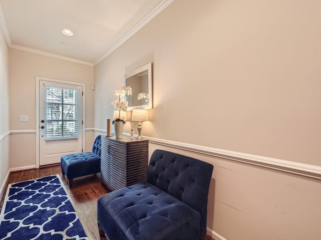 Sitting room with dark hardwood / wood-style floors and ornamental molding