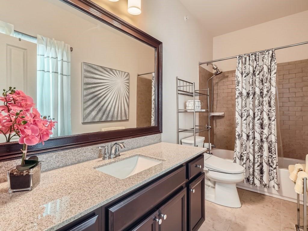 Full bathroom featuring tile flooring, shower / bath combo, toilet, and vanity