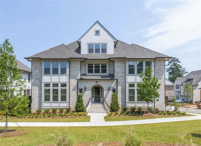 Brick and siding exterior with multiple gables and a prominent front entrance