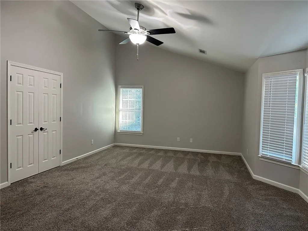 Primary bedroom with double doors to ensuite bath