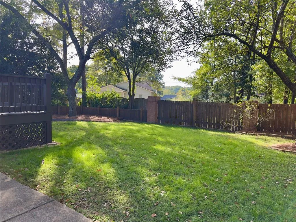 Fully fenced backyard with deck