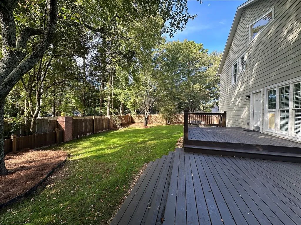 Fully fenced backyard with expansive deck