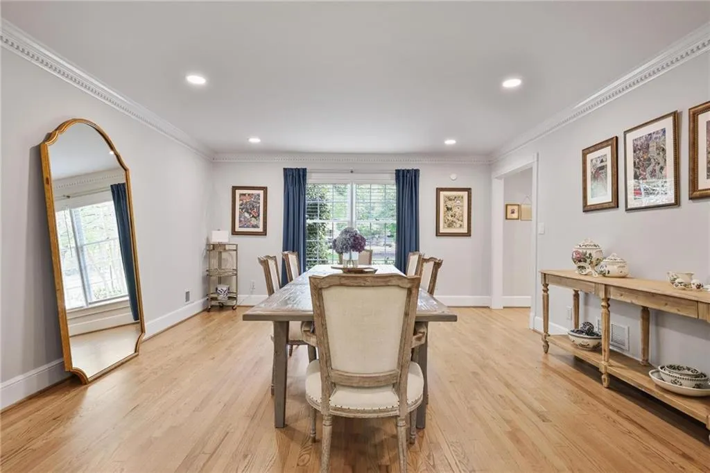 Dining space featuring ornamental molding, light wood finished floors, and recessed lighting