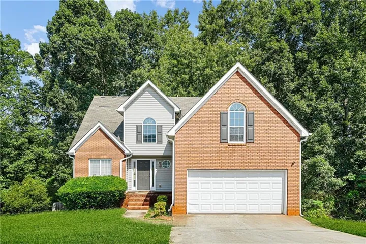 Brick and siding exterior with a two-car garage