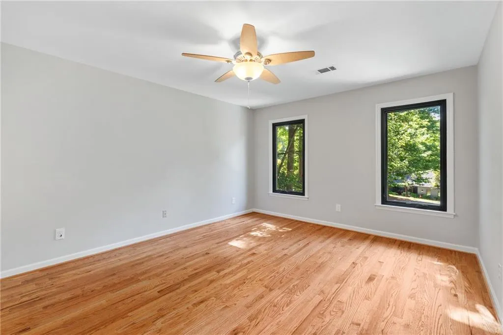 Spare room featuring light hardwood / wood-style floors and ceiling fan