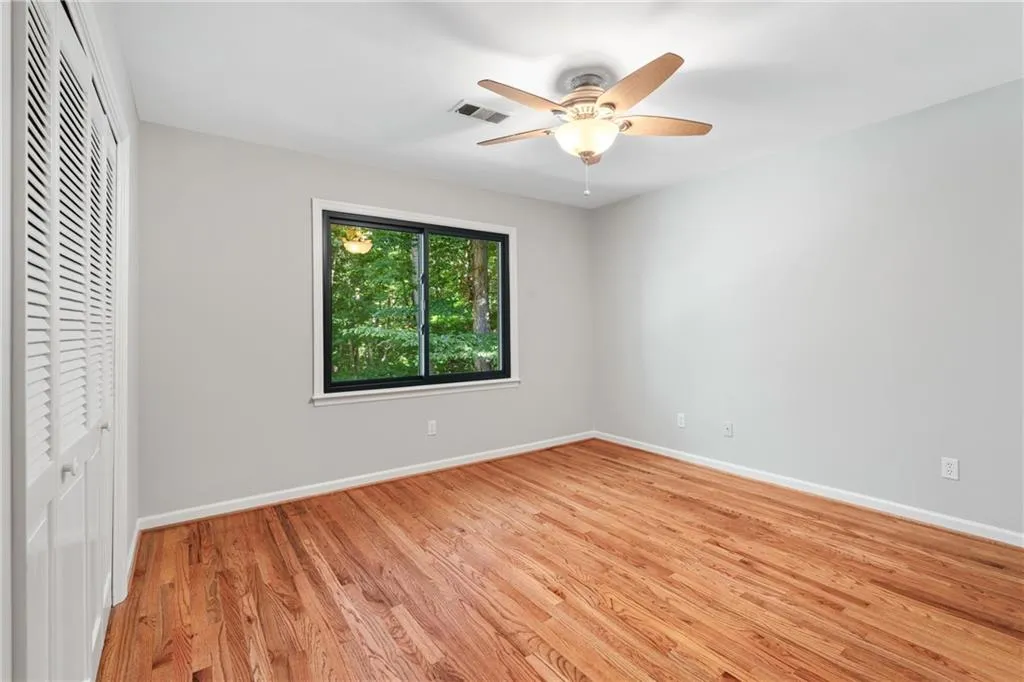 Unfurnished bedroom featuring light hardwood / wood-style flooring, a closet, and ceiling fan