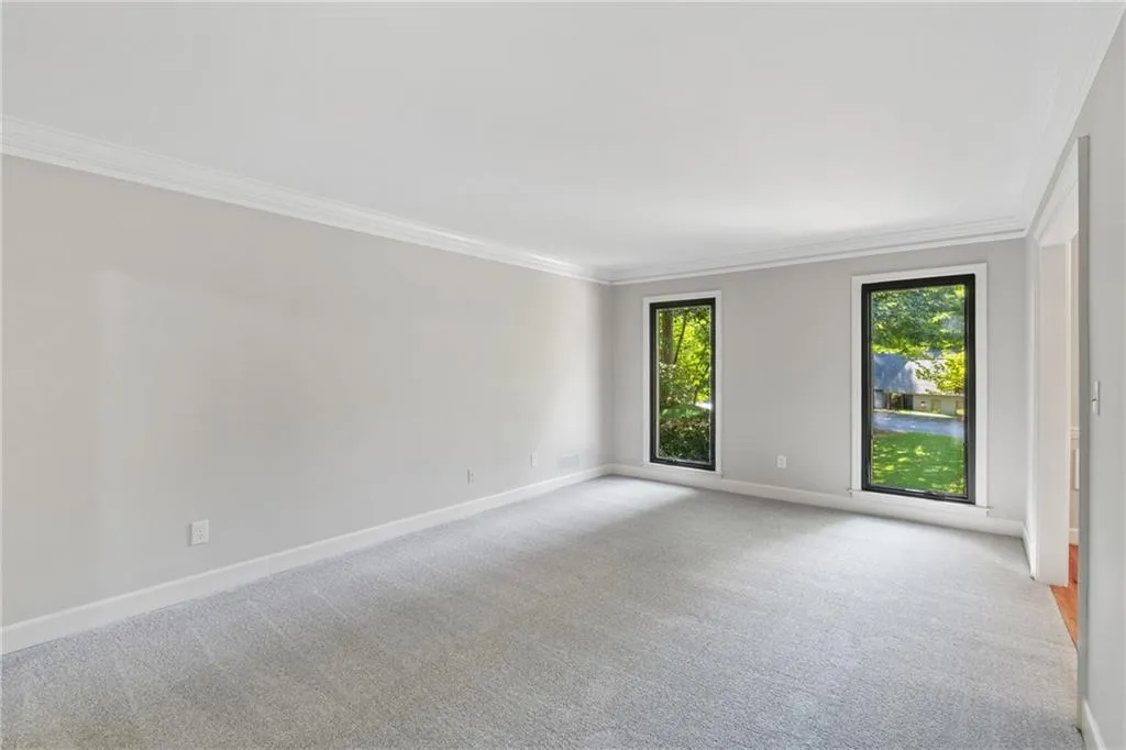 Unfurnished room with carpet floors and ornamental molding
