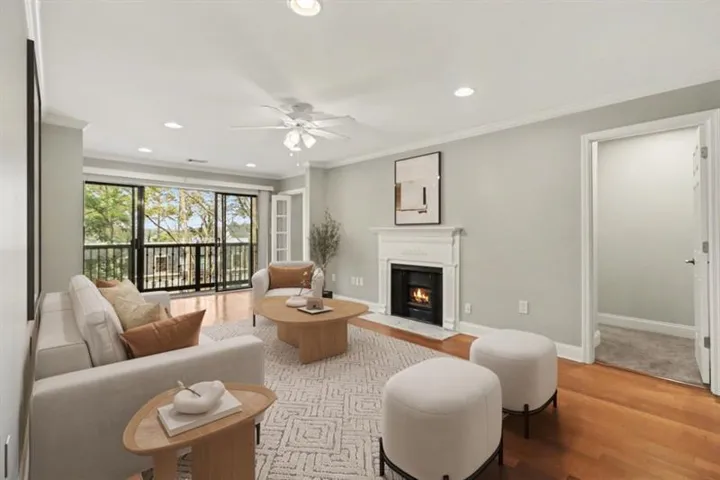 Step inside to find Hardwood Floors, an Updated Kitchen with Granite Counters, and a spacious Open Living Room anchored by a Gas Fireplace with marble surround.