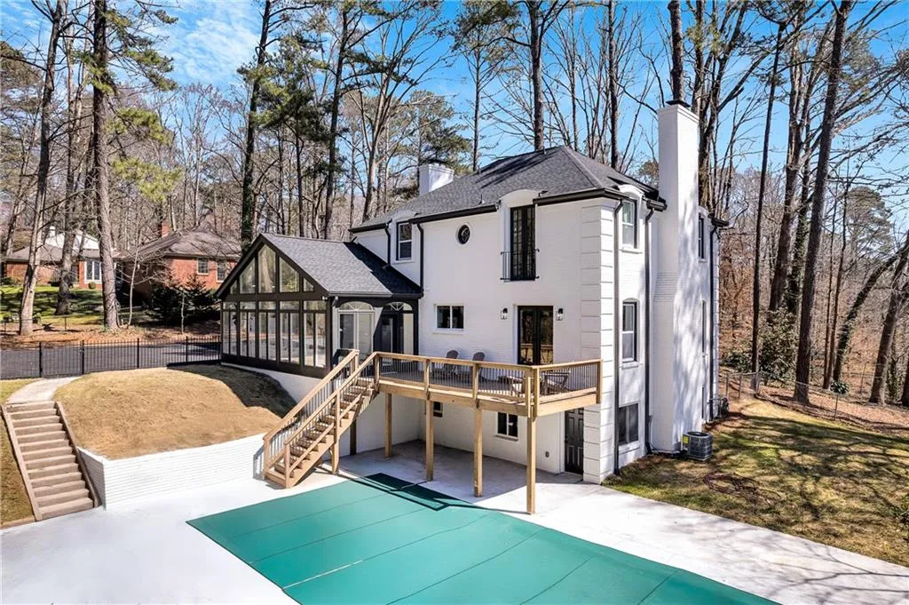 Rear view of house featuring stairway, cooling unit, a chimney, a deck, and a patio area