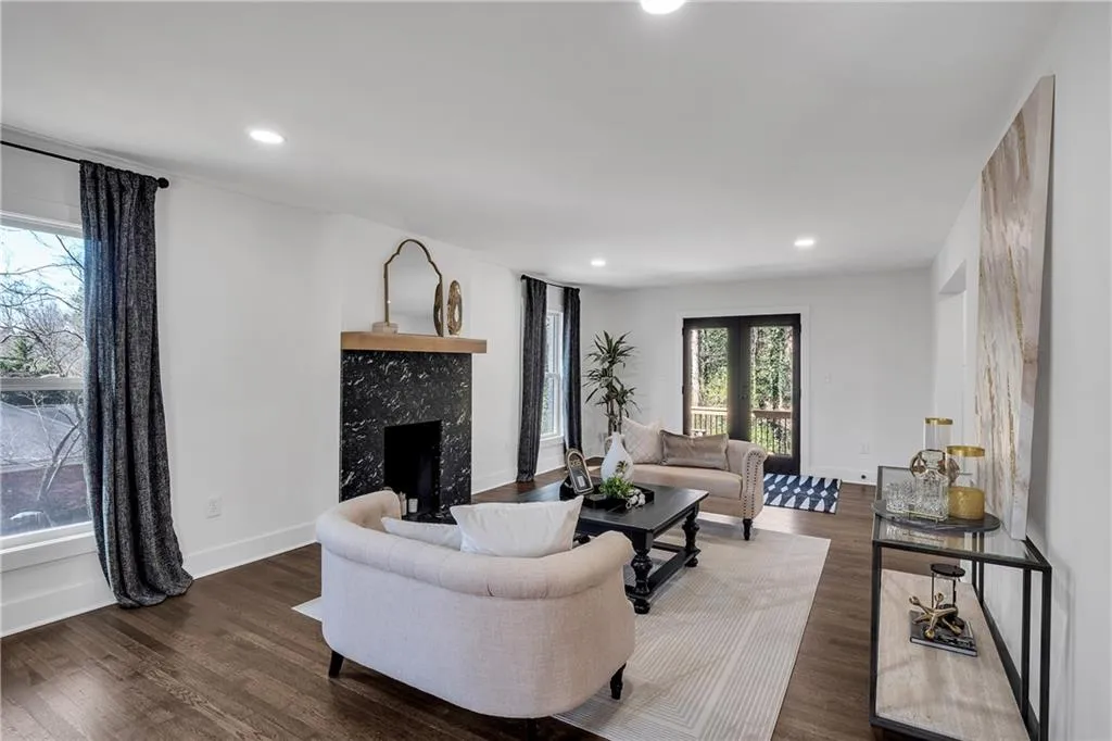 Living area with a high end fireplace, recessed lighting, baseboards, and wood finished floors