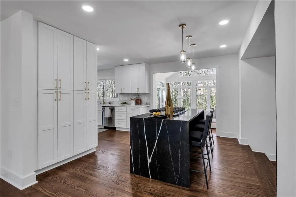 Kitchen with tasteful backsplash, recessed lighting, dishwasher, and white cabinetry