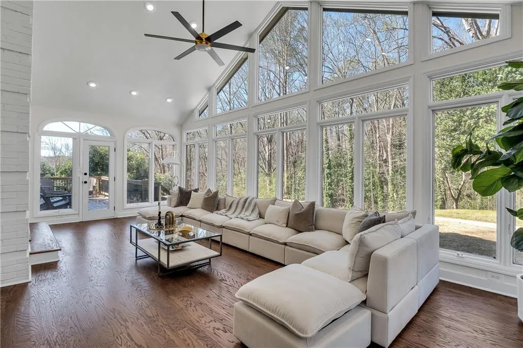 Sunroom featuring a healthy amount of sunlight, ceiling fan, and vaulted ceiling