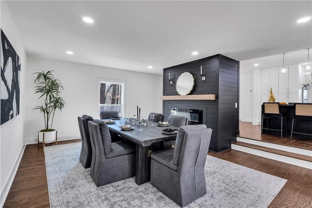 Dining space with a fireplace, recessed lighting, wood finished floors, and baseboards