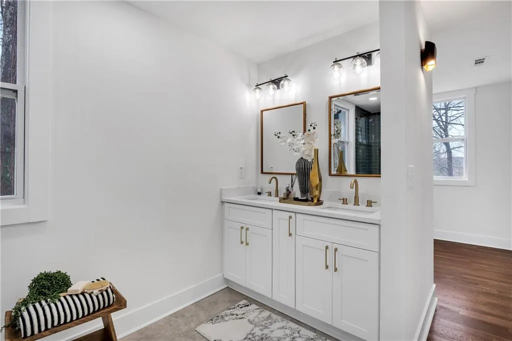 Bathroom featuring baseboards, visible vents, and a sink