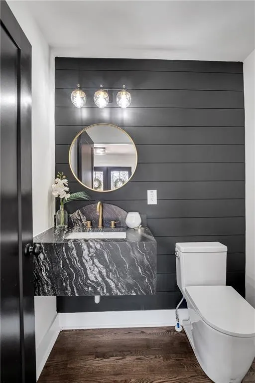 Bathroom with toilet and wood finished floors