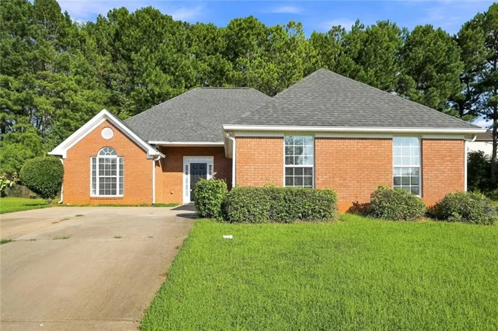 Brick exterior with gabled roof lines and an arched window