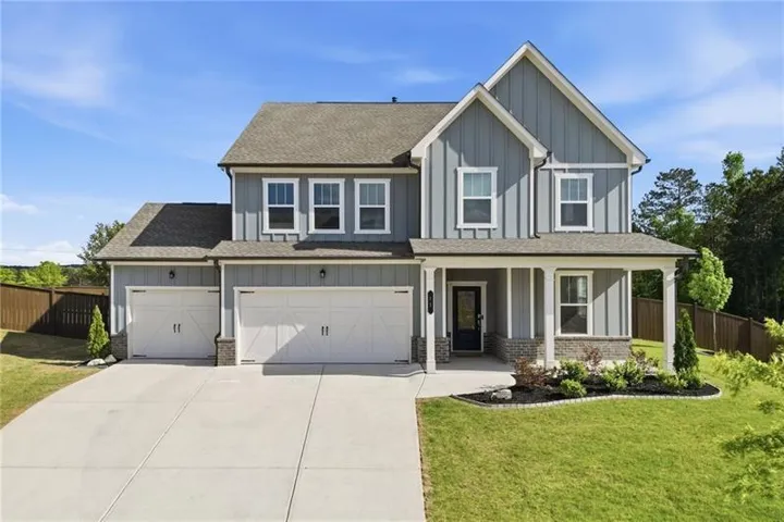 Elegant two-story Colonial with gray board-and-batten siding and white trim accents