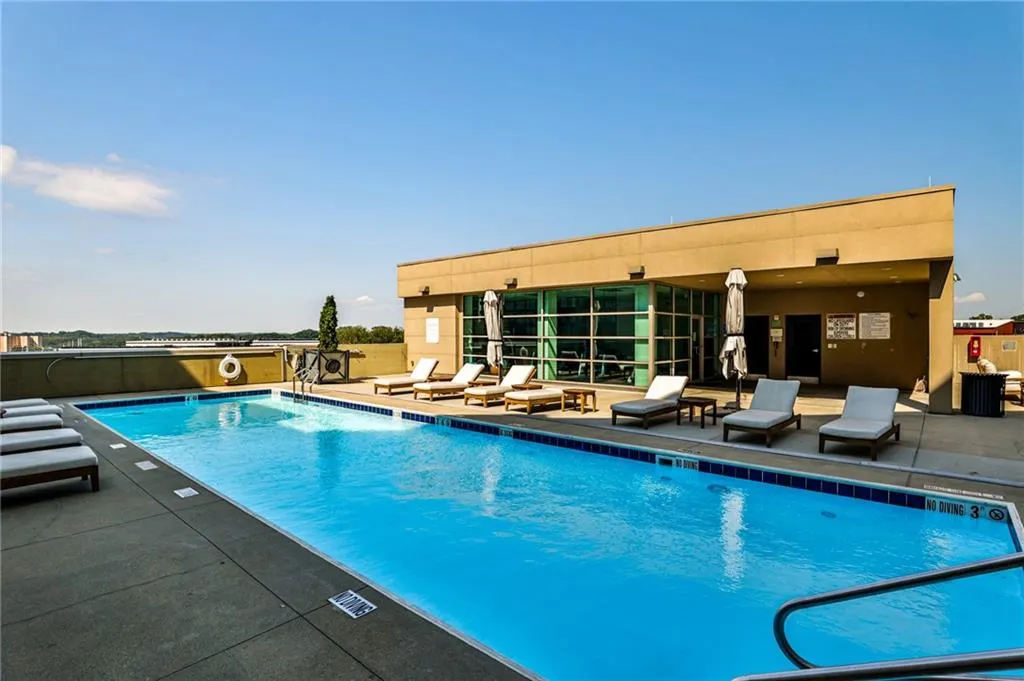 Rooftop pool with lounge seating and skyline views—perfect for relaxing or entertaining above the city