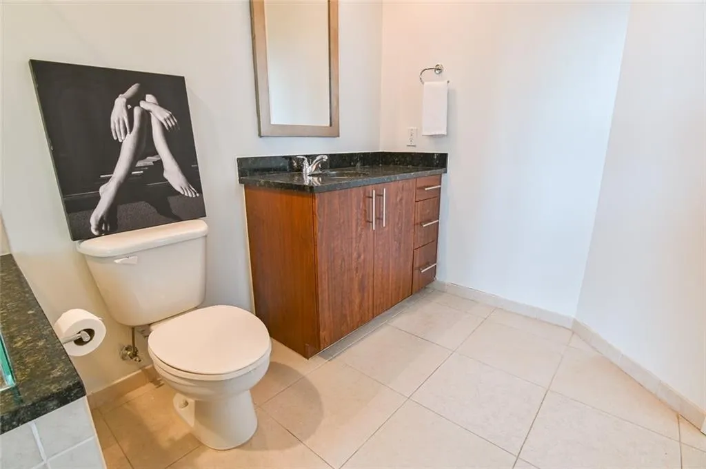 Half bathroom featuring vanity and tile patterned flooring