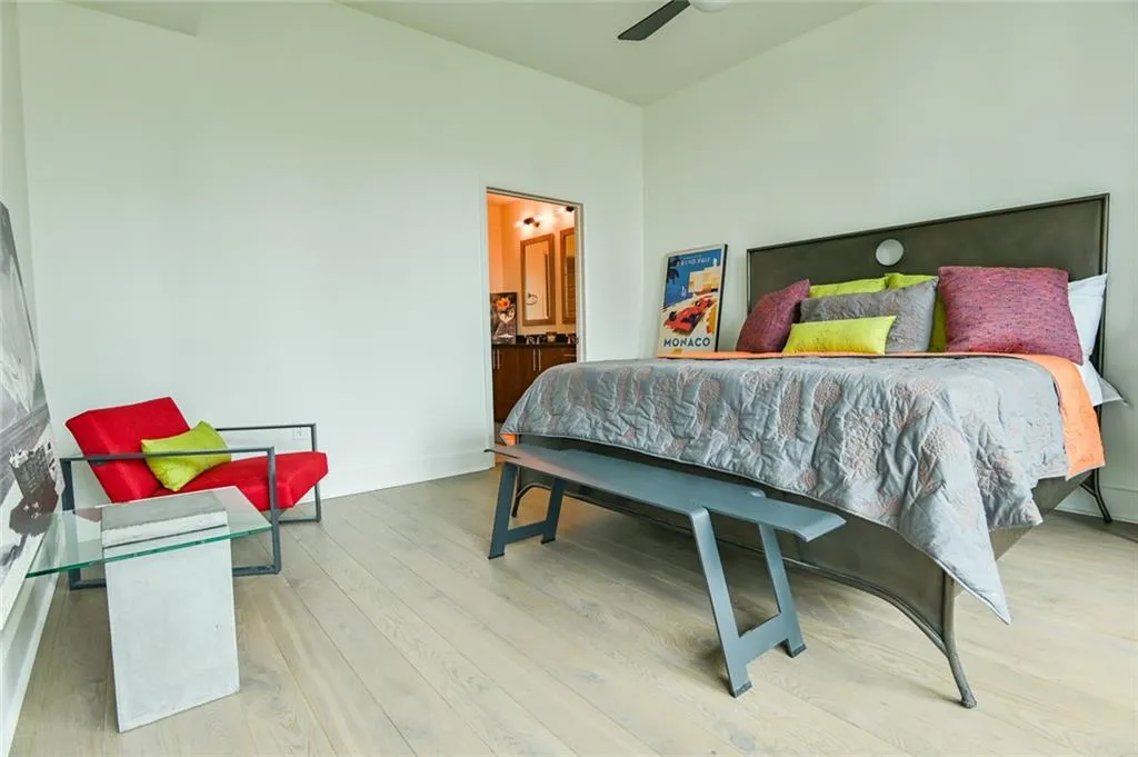 Bedroom featuring wood finished floors and ensuite bathroom
